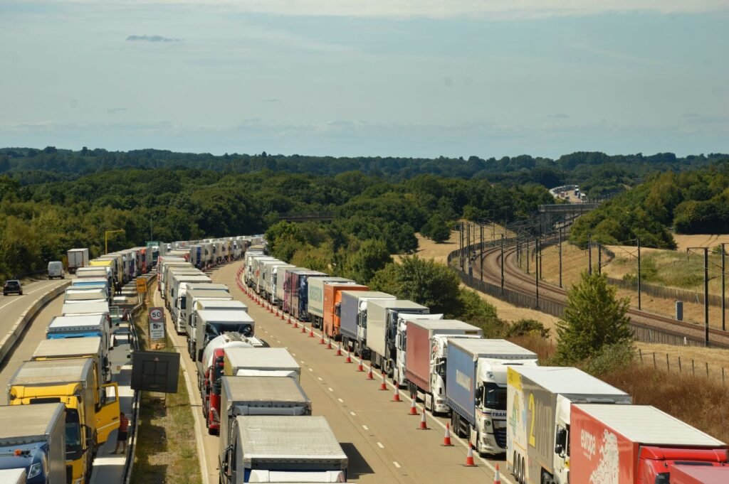 Long line of HGVs on a motorway through the countryside